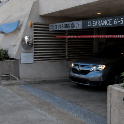 CAR1806 illuminated CAR alley warning sign installed at a single-lane parking garage exit to alert pedestrians and approaching drivers of an exiting vehicle.