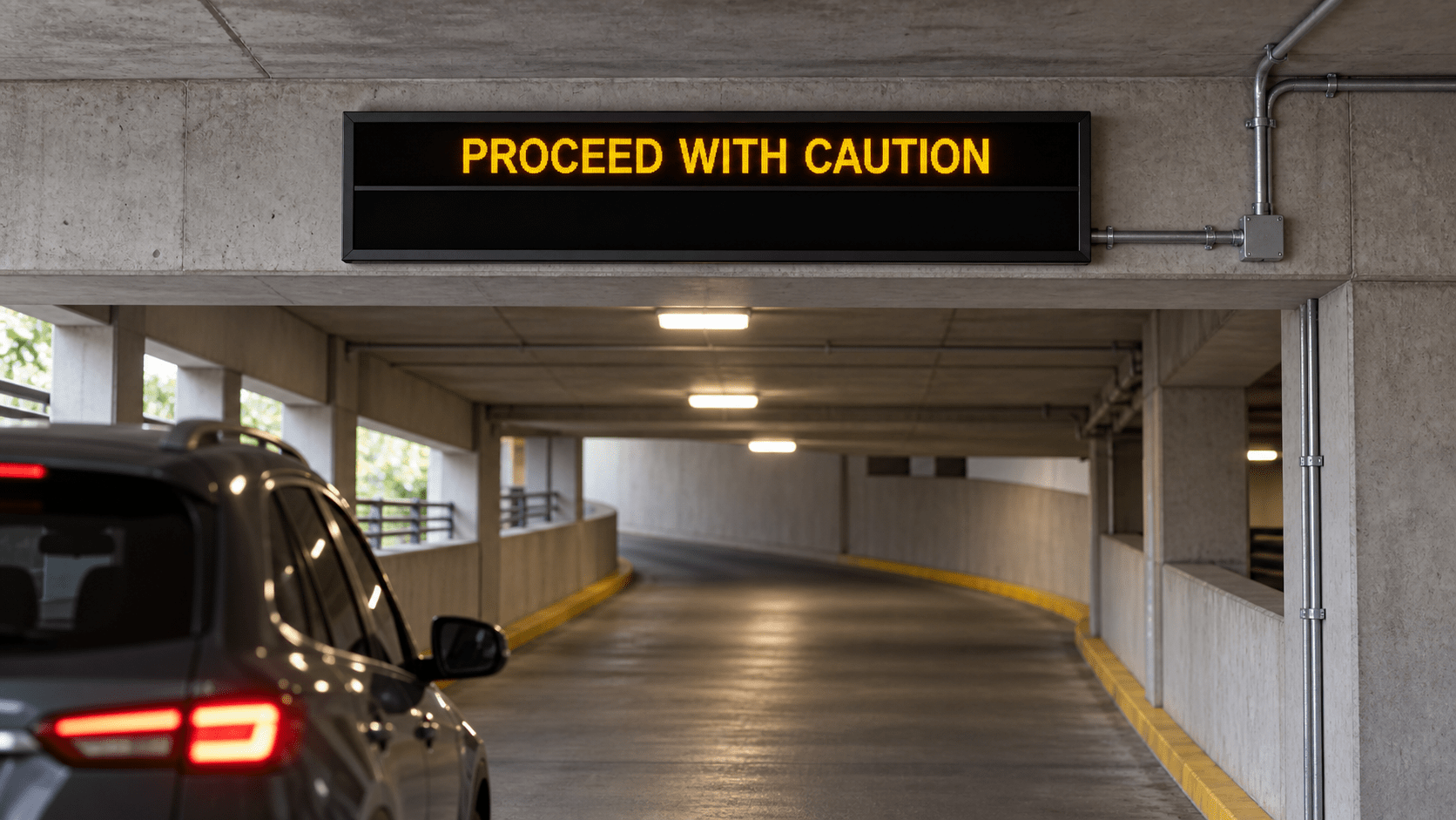 Custom dual message sign showing Proceed With Caution in a parking garage