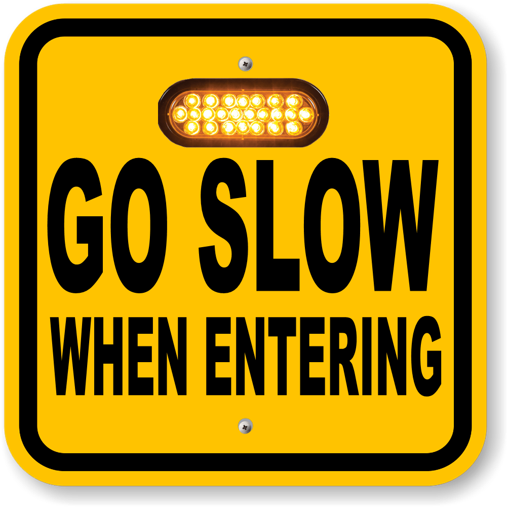 Yellow GO SLOW WHEN ENTERING custom warning sign with an amber LED module above the printed message